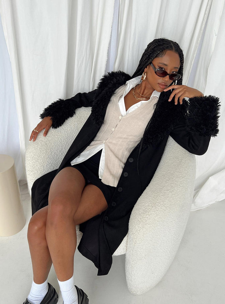 Pristine | Women’s long black trench coat with faux fur trim and button front
